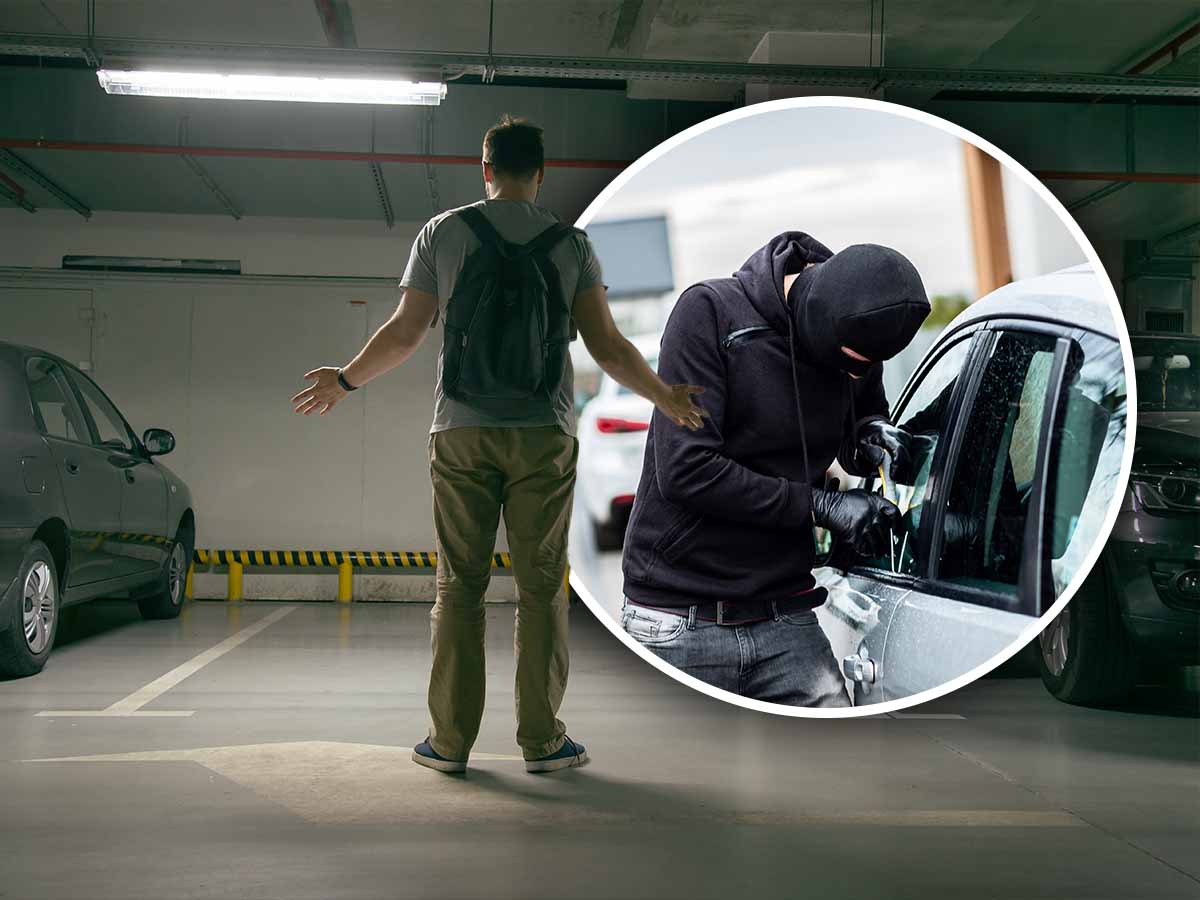 un ladro tenta di forzare la portiera di un'auto